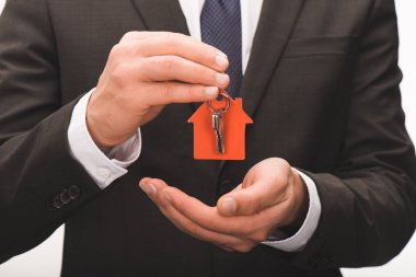 cropped image of man holding key from house isolated on white clipart