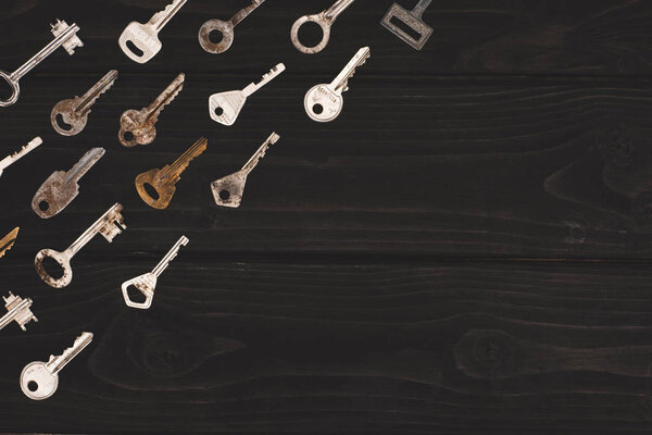 top view of different vintage keys on black table