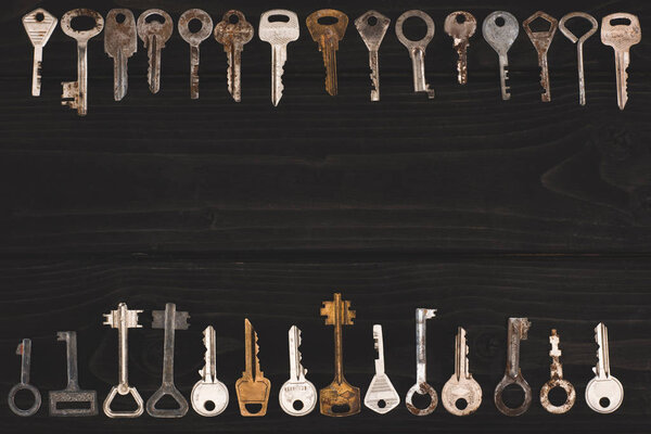 top view of vintage keys frame on black table