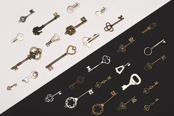 top view of different vintage keys over black and white background