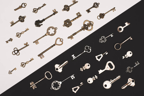 top view of different vintage keys over black and white background