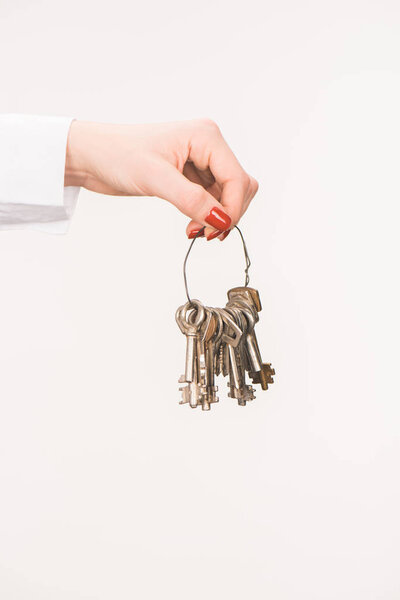 cropped image of female hand holding keys isolated on white