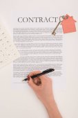 top view of cropped hand signs contract of buying house isolated on white