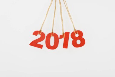 close up view of 2018 year sign hanging on strings isolated on white clipart