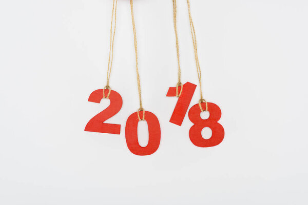 close up view of 2018 year sign hanging on strings isolated on white