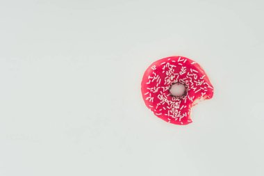 top view of bitten pink glazed doughnut isolated on white clipart