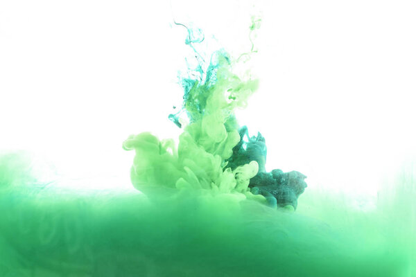 mixing of green paint splashes isolated on white