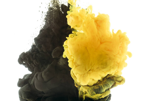 mixing of black and yellow paint, isolated on white