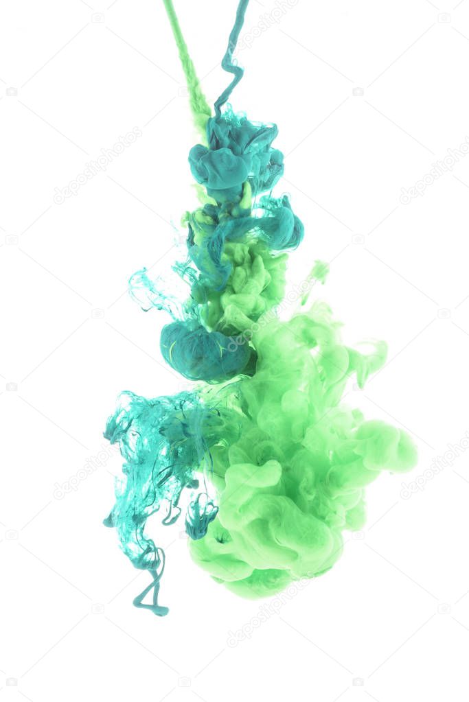 mixing of green paint splashes isolated on white