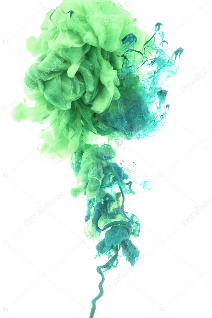 mixing of green paint splashes isolated on white