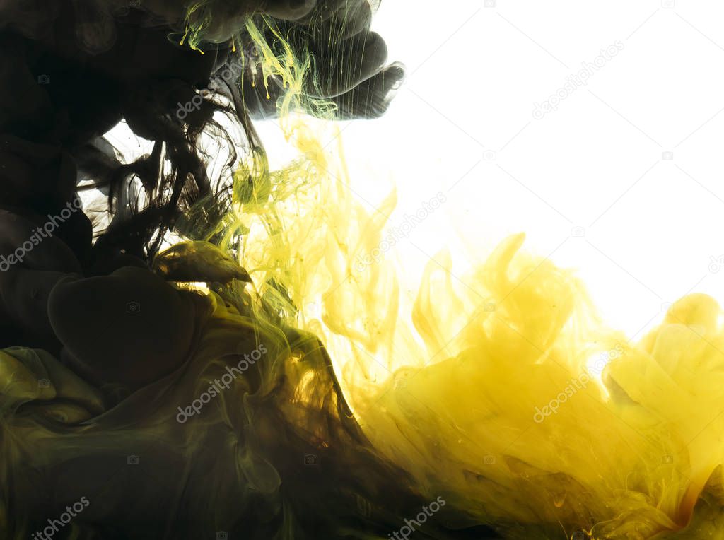 mixing of black and yellow paint, isolated on white