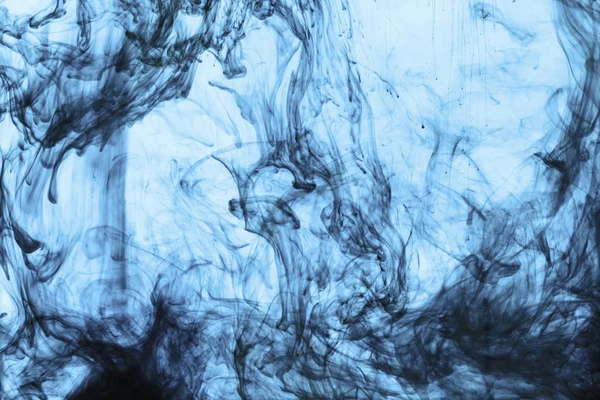 background with swirls of blue paint in water