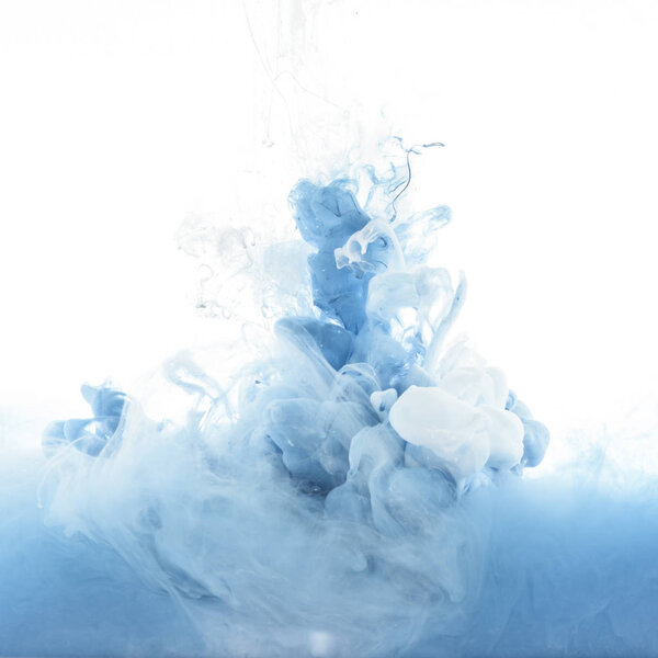 close up view of mixing of blue and white paint splashes isolated on white