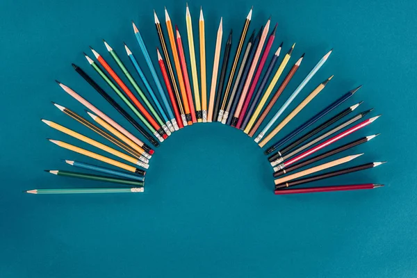 青の背景に分離されたカラフルな鉛筆の組成の平面図 — ストック写真