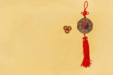 top view of chinese yin and yang talisman with coins on yellow clipart
