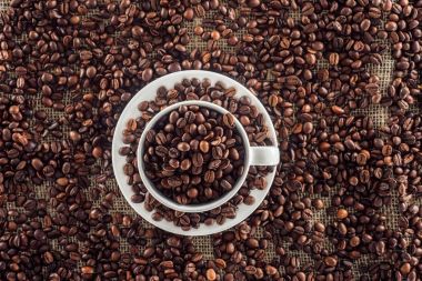 top view of coffee cup and roasted coffee beans on sack clothes clipart