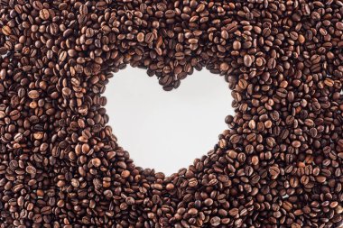 top view of heart made from roasted coffee beans on white  clipart