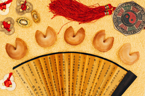 top view of chinese talismans and fortune cookies on golden surface, Chinese New Year concept