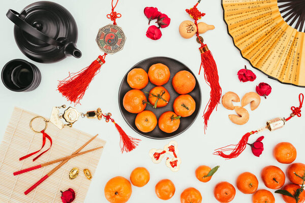 top view of various chinese talimans with tangerines and tea isolated on white, Chinese New Year concept