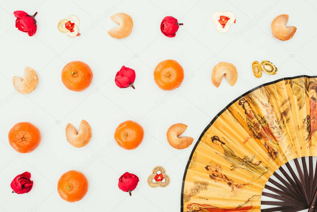 top view of chinese new year composition with handheld fan isolated on white