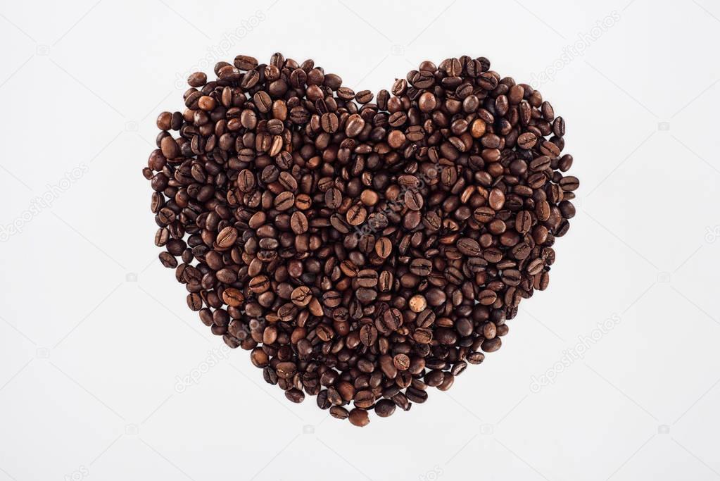 close-up view of heart made from roasted coffee beans isolated on white 
