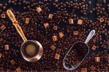 flat lay with roasted coffee beans, coffee brewer and metal scoop clipart