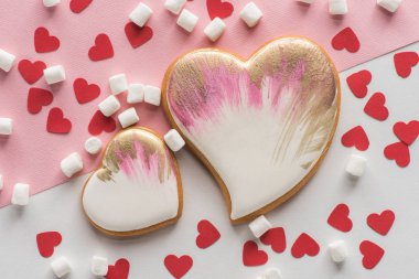 close up view of heart shaped cookies, sweet marshmallow and confetti, st valentines day concept clipart