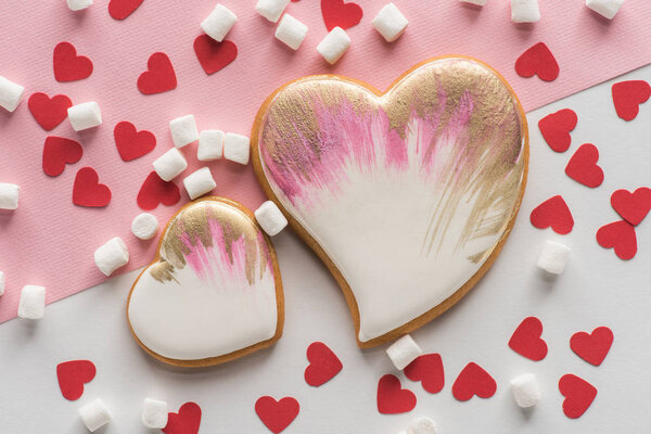 close up view of heart shaped cookies, sweet marshmallow and confetti, st valentines day concept