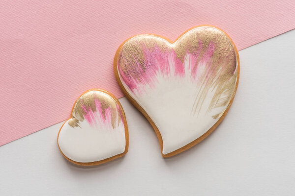 top view of glazed heart shaped cookies isolated on pink surface