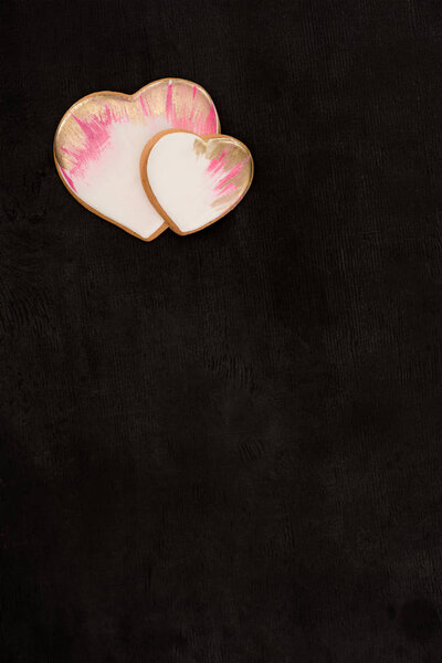 top view of heart shaped cookies on dark surface