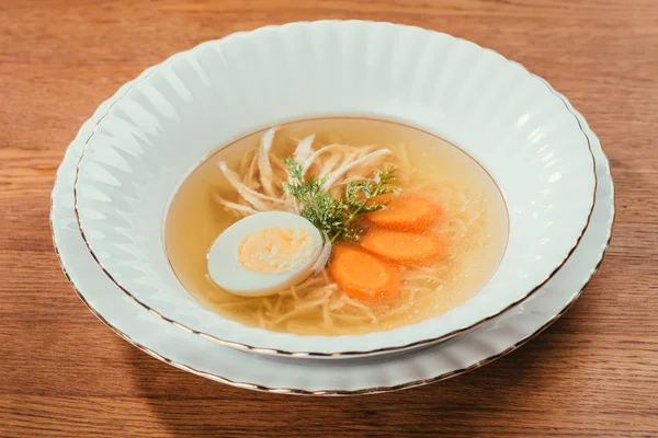 Chicken soup with vegetables and egg in white plate on wooden table — Stock Image Chicken Soup Vegetables Egg White Plate Wooden Table Stock Picture
