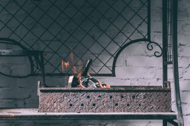 grill with fire, flames and charcoals indoors clipart