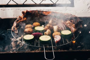 close-up view of delicious meat and vegetables preparing on grill clipart