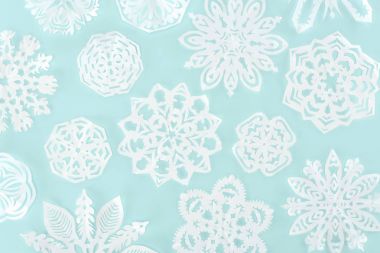 christmas background with decorative paper snowflakes, isolated on light blue clipart