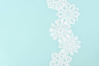 decorative christmas snowflakes, isolated on light blue with copy space clipart