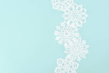 decorative christmas snowflakes, isolated on light blue with copy space clipart