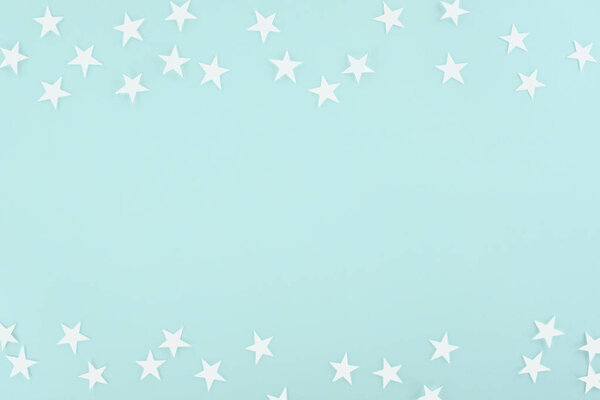 background with white paper stars, isolated on light blue