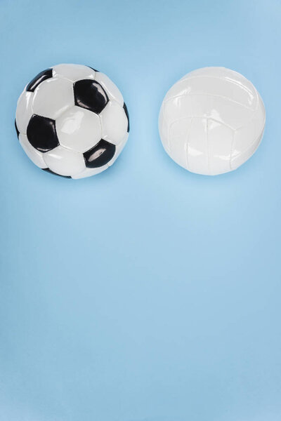 Balls for soccer and volleyball isolated on blue