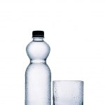 Plastic bottle of water and empty glass isolated on white