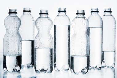 plastic bottles of water in row isolated on white clipart