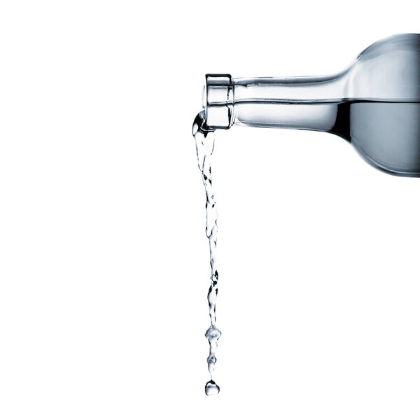 water pouring from glass bottle isolated on white