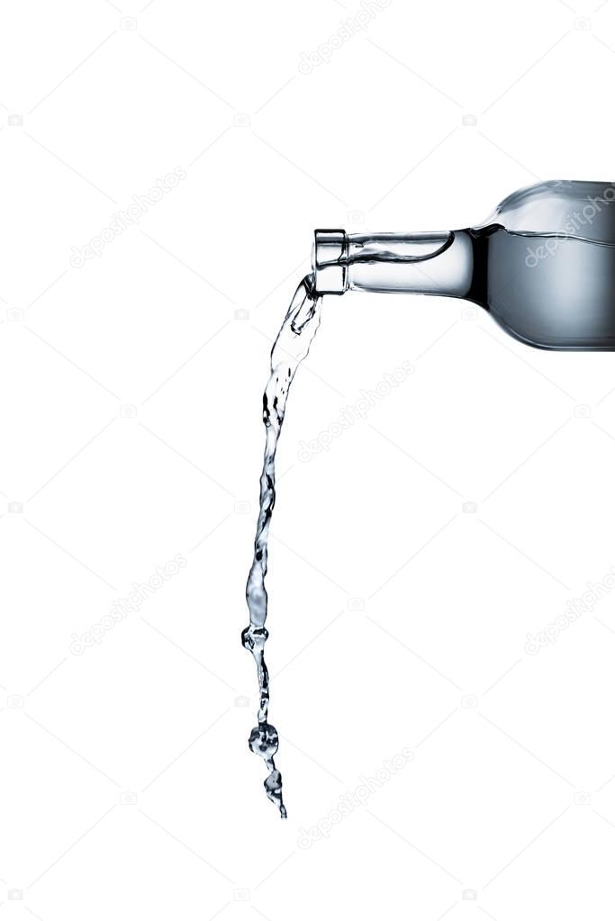water pouring from glass bottle isolated on white