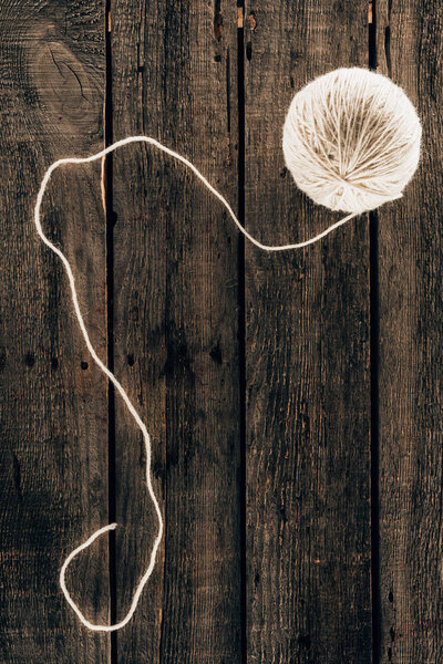 top view of knitting yarn ball on wooden background