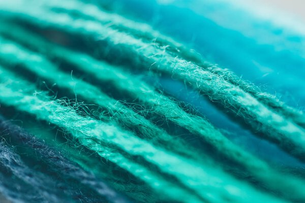 close up view of blue and green nitting yarn ball
