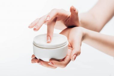 cropped shot of woman taking moisturizing cream from jar isolated on white clipart