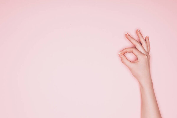 cropped shot of woman showing okay sign isolated on pink