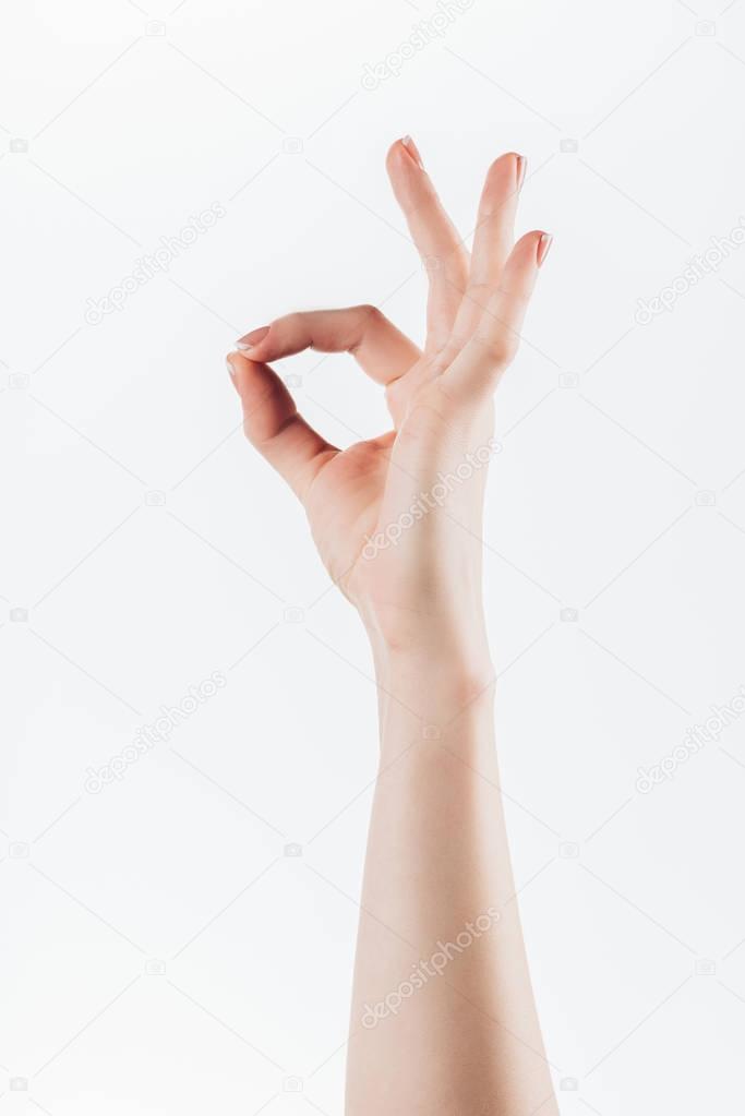 cropped shot of woman showing okay sign isolated on white