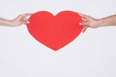 cropped shot of woman and man holding red heart isolated on white, st valentines day concept clipart