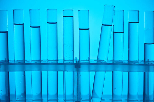glass tubes on stand for chemical analysis on blue
