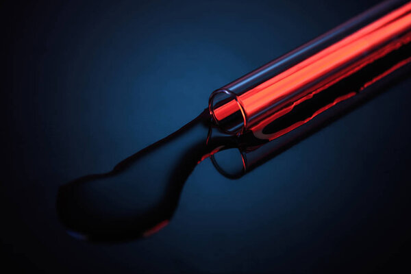 spilled liquid from glass tube on table in laboratory